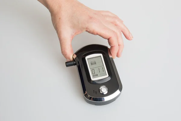 Hands of woman holding a digital Alcohol Breath Tester — Stock Photo, Image