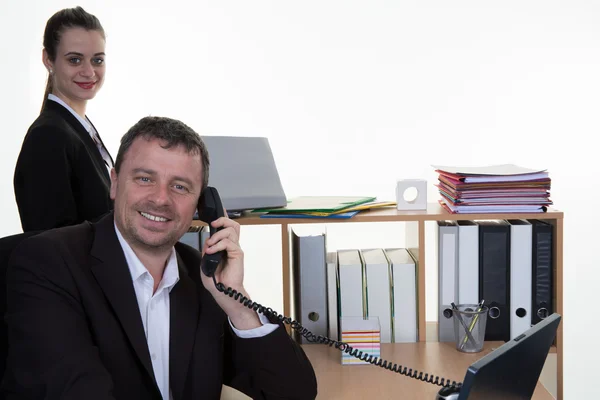 Happy businessman talking over phone while standing in creative office — Stock Photo, Image