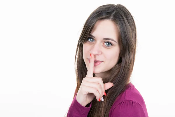 Beautiful woman with bare shoulders making a shushing gesture Royalty Free Stock Images