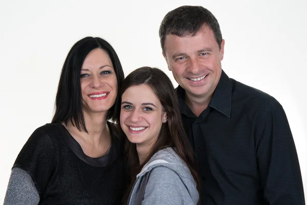 Una familia feliz sobre un fondo blanco con una adolescente — Foto de Stock