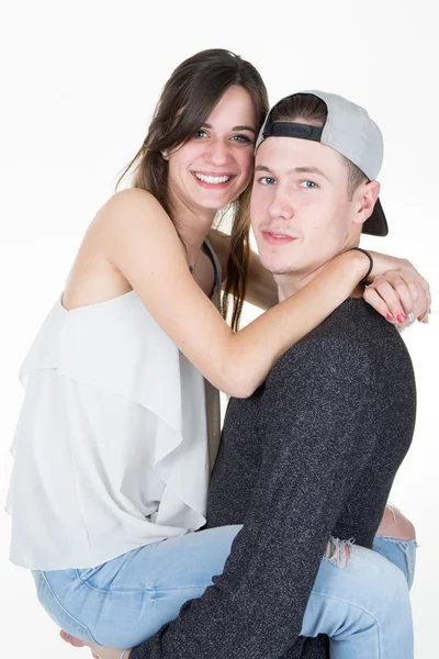 Young couple standing on white background against white — Stockfoto
