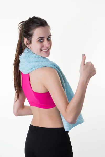 Šťastný fitness mladá žena stojící zobrazeno palec nahoru — Stock fotografie