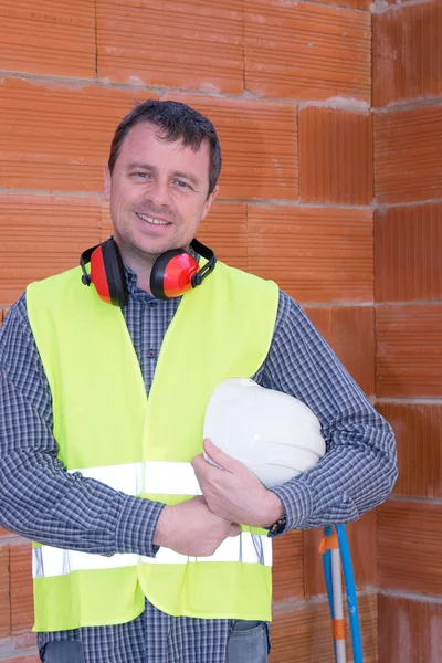 Construction Worker in a construction site with helmet — Stock Photo, Image