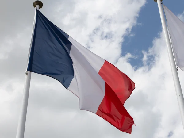 Bandeira da França no mastro sob céu azul nublado — Fotografia de Stock