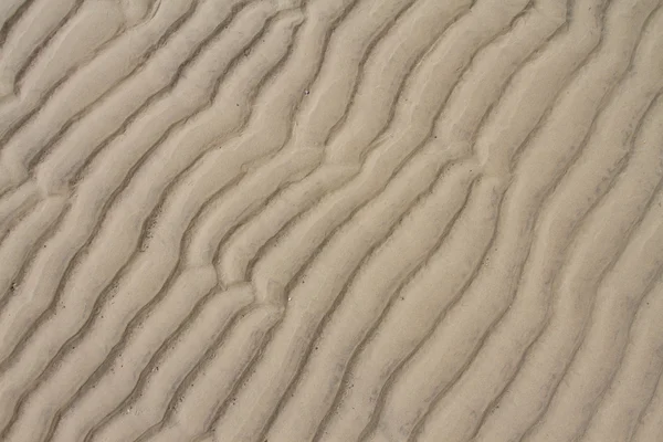 Närbild på sand mönster på en strand i sommar — Stockfoto