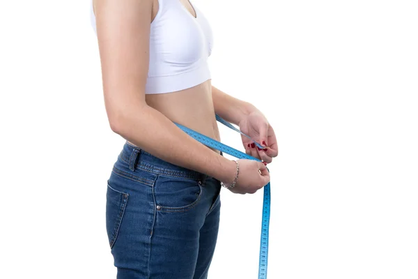 Woman measuring her waist with tape after loosing weight Royalty Free Stock Images