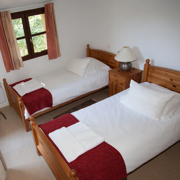 Dos camas individuales en un acogedor dormitorio en una casa luminosa — Foto de Stock