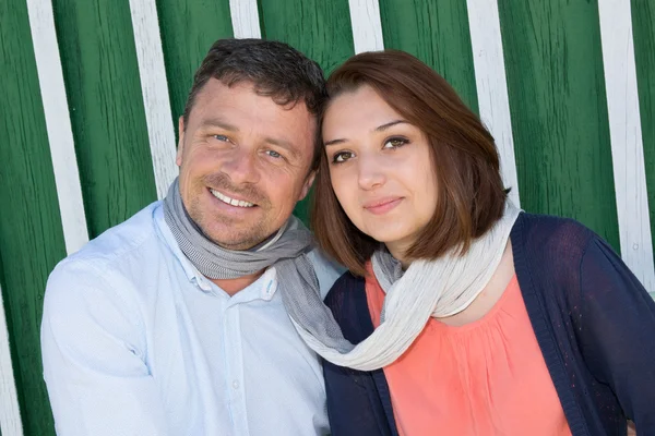 Happy couple with a scarf looking at the camera — Stock Photo, Image