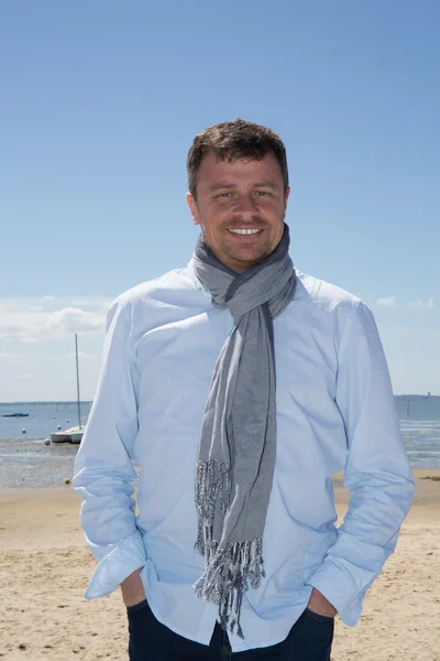 Portrait of smiling gorgeous handsome man with scarf relaxing on vacation — Stock Photo, Image