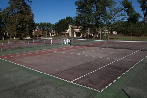 Empty tennis court under a blue sky Royalty Free Stock Images