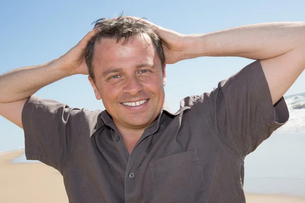 Charming middle aged man standing at the beach — Stock Photo, Image