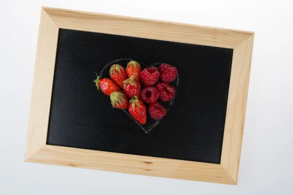 Red heart with strawberry on black background.Valentine hearts concept. — Stock Photo, Image