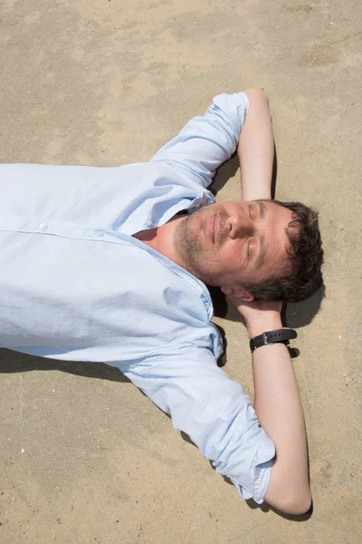 Hombre guapo relajándose en la playa, usando ropa ligera y cómoda — Foto de Stock