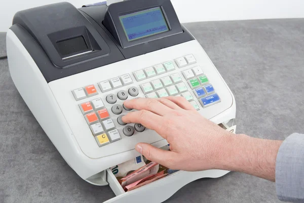 Hand open the cash register and giving change in euro — Stock Photo, Image