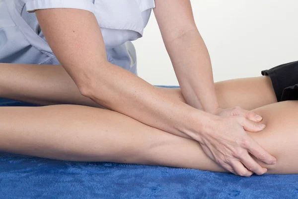 Close up of tight of a woman massaging by therapist — Stock Photo, Image