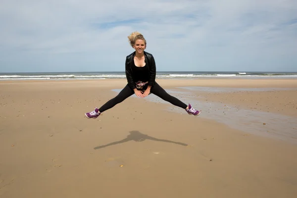 The girl is happy dances at the beach on summer