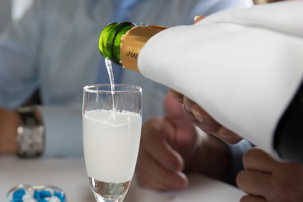 Wlewanie szampana do szklanki na uroczystości weselnej — Zdjęcie stockowe