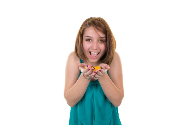 Portrait of a young woman eating or offering colorful candies — Stock Photo, Image