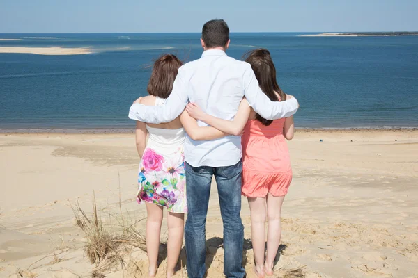 Father holding his two daughter at the beach — Stock Photo, Image