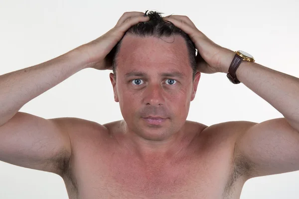 Portrait of a man combing his hair with hands — Stock Photo, Image