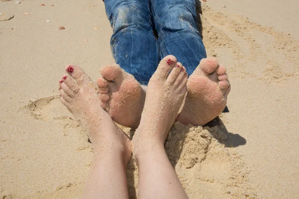stock image happy feet on the beach touching together, loving foot