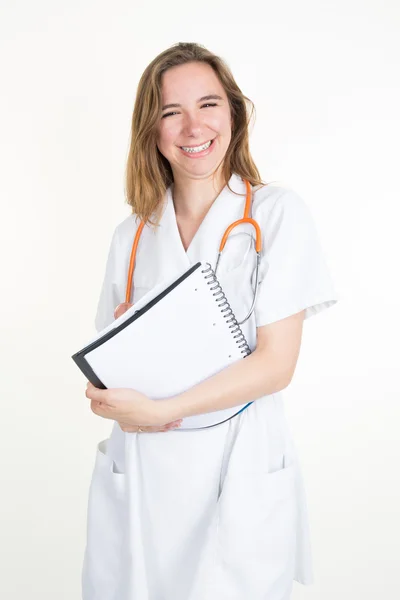 Smiling female doctor with a folder in uniform standing — Stock Photo, Image