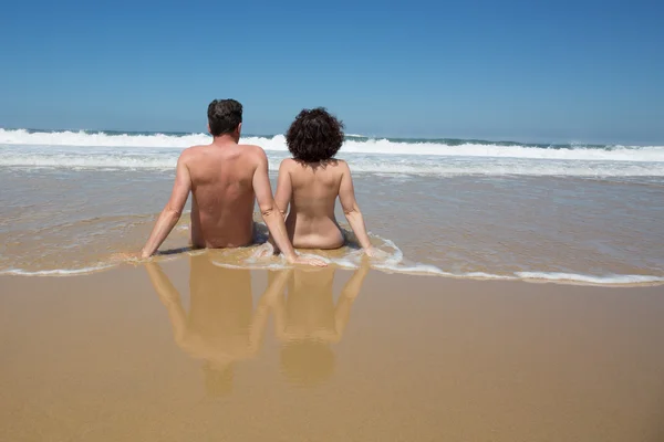 カメラ裏面のビーチで水のカップル ストックフォト