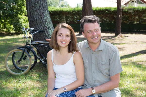 Et ungt par på sykkeltur på en solrik dag i skogen – stockfoto