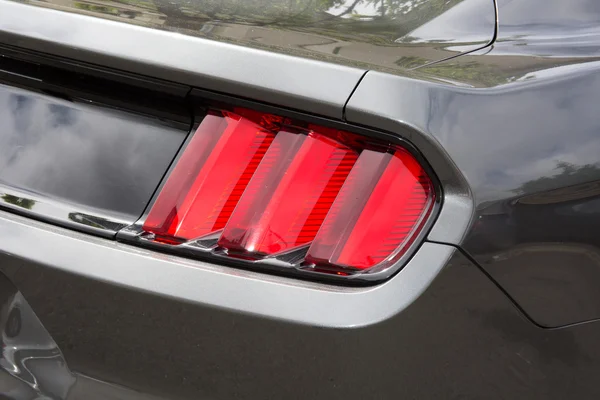 Luz de fondo roja de un coche deportivo gris — Foto de Stock