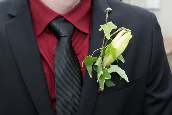 Groom's in a suit with a white flower on Boutonniere — Stock Photo, Image