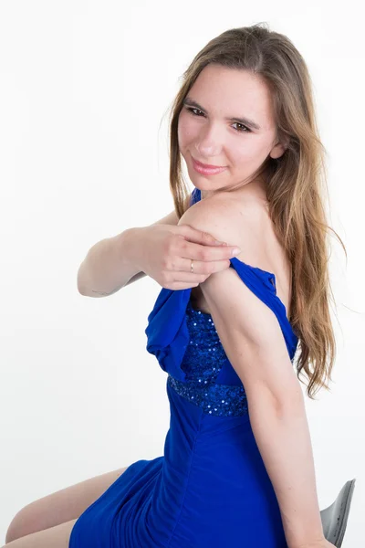 Sexy woman long hair white background blue dress sitting chair — Stock Photo, Image