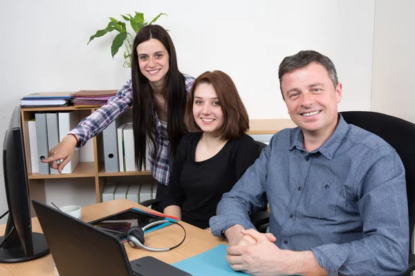 Successful businessteam of three sitting in office and planning work — Stock Photo, Image