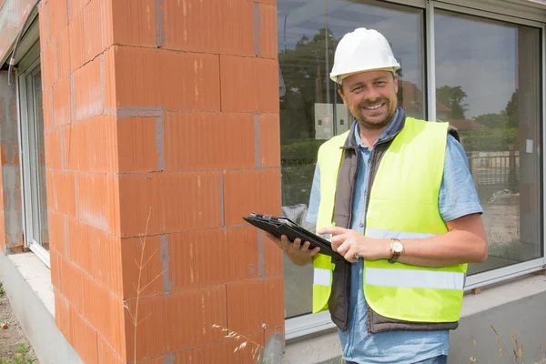 Entrepreneur on construction site using electronic tablet — Stock Photo, Image