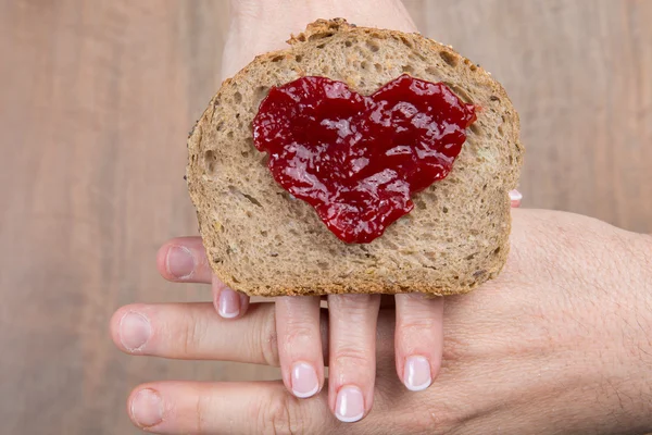 Toast bread with jam shape of hearts, vintage wooden table. — Stock Photo, Image