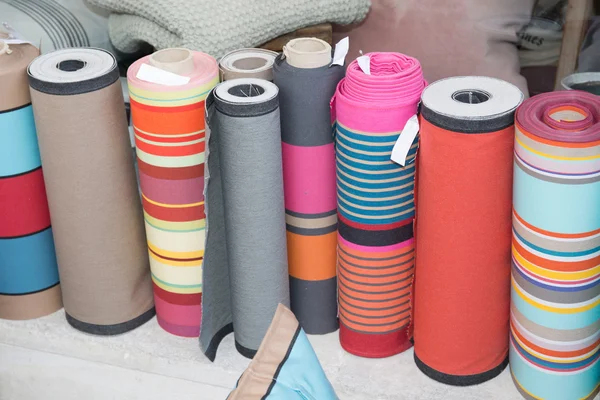 Colorful fabric rolls. Focus on front part of rolls — Stock Photo, Image