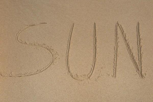 Written word "Sun" on sand of beach — Stock Photo, Image