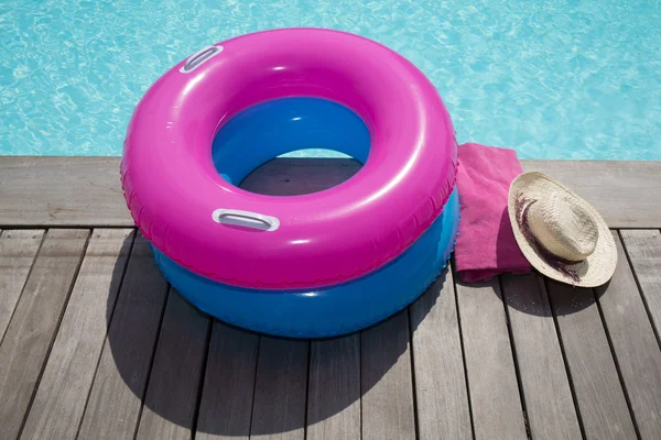 Pool ring and swimming pool on wooden deck summertime — Stock Photo, Image