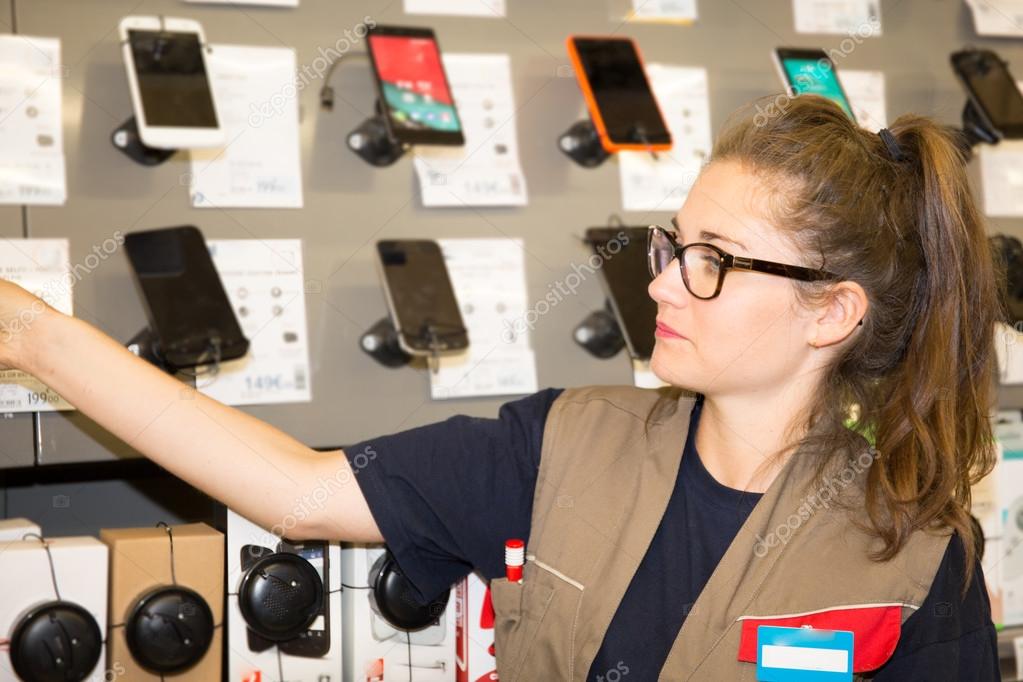 Young woman department store choosing selling cell phone