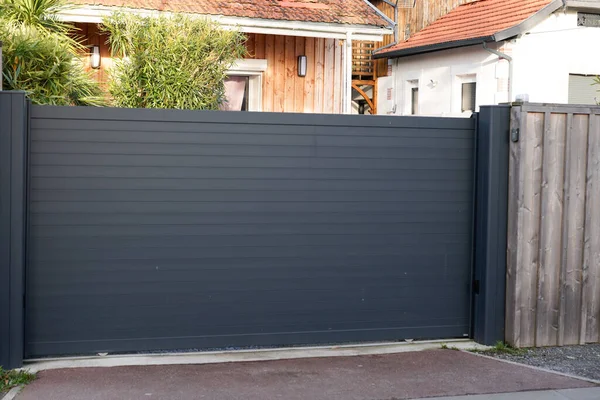 sliding gate steel big grey metal portal fence on modern house street