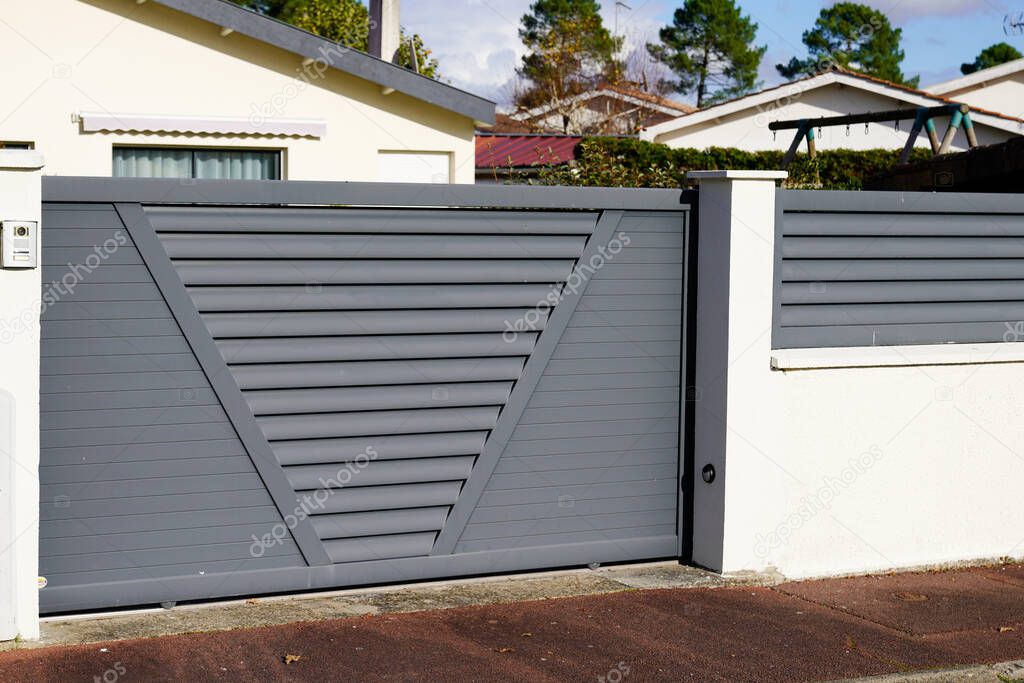 gray sliding gate of the detached house in suburb