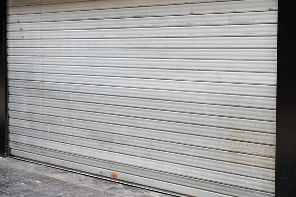 shuttered shop with closing down out of business in turn down in the economy