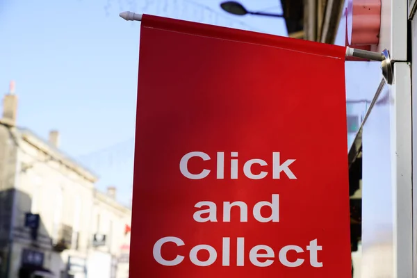 Click and Collect flag sign on shop street order shopping online and collect from a local store for free