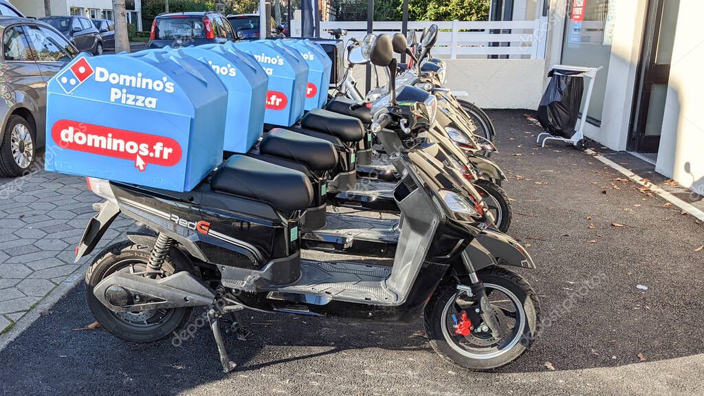 Dominos pizza logo and text sign on delivery scooter for restaurant Domino's American pizzas fastfood