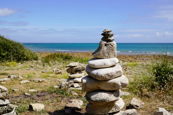 Pile of pebbles zen balanced stones stack on sea coast beach