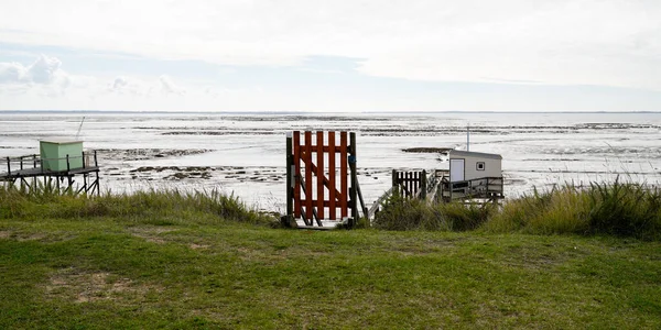 Typical old wooden door to access fishing huts on stilts in the atlantic ocean