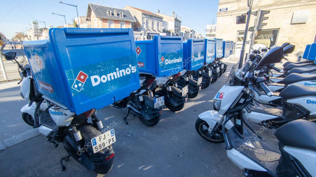 Bordeaux , Aquitaine  France - 01 18 2021 : Dominos pizza text sign of restaurant Domino's pizza chain brand with delivery scooter with logo