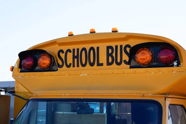 yellow school bus Front view with text sign and security light