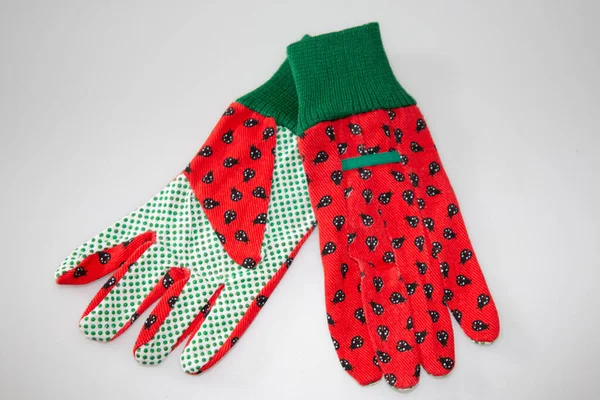 new red and green gloves for gardening and DIY at home fashion over white grey background