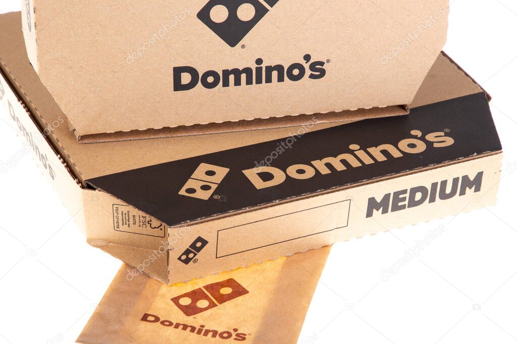 Bordeaux , Aquitaine France - 04 07 2021 : Dominos pizza sign text and brand logo of american restaurant on several brown carton box Domino's pizza us chain