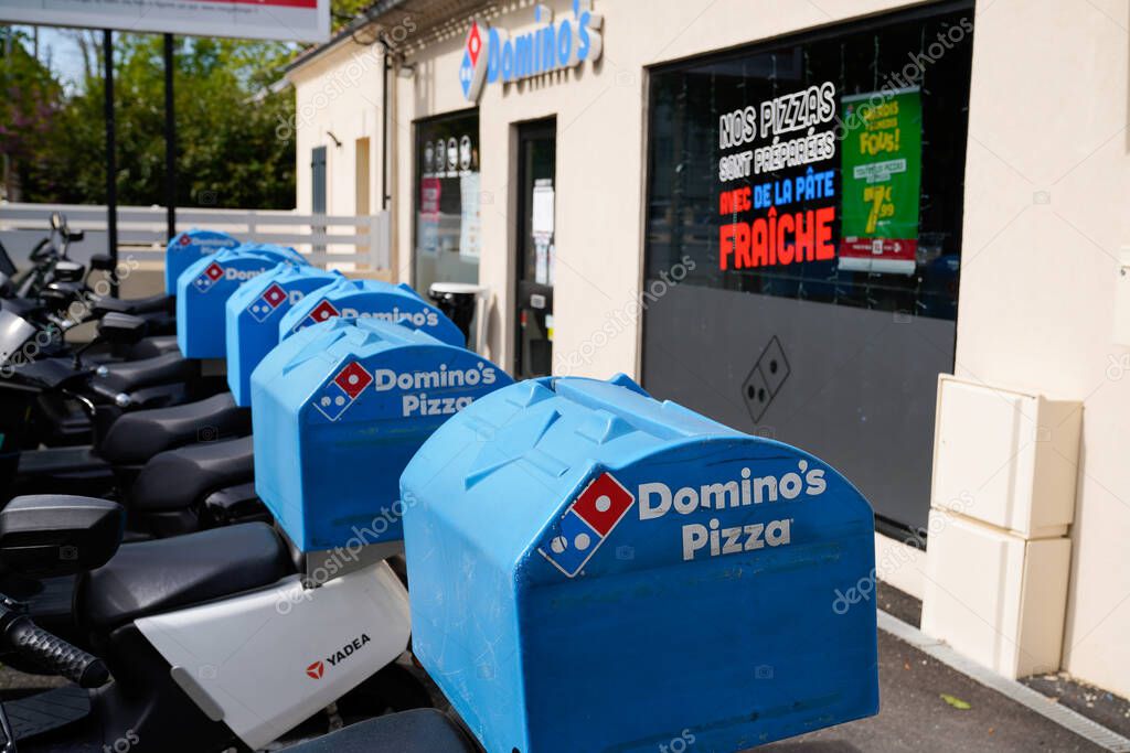 Bordeaux , Aquitaine France - 04 15 2021 : Dominos pizza brand logo and text sign on bag case motorbike delivery scooter for restaurant Domino's